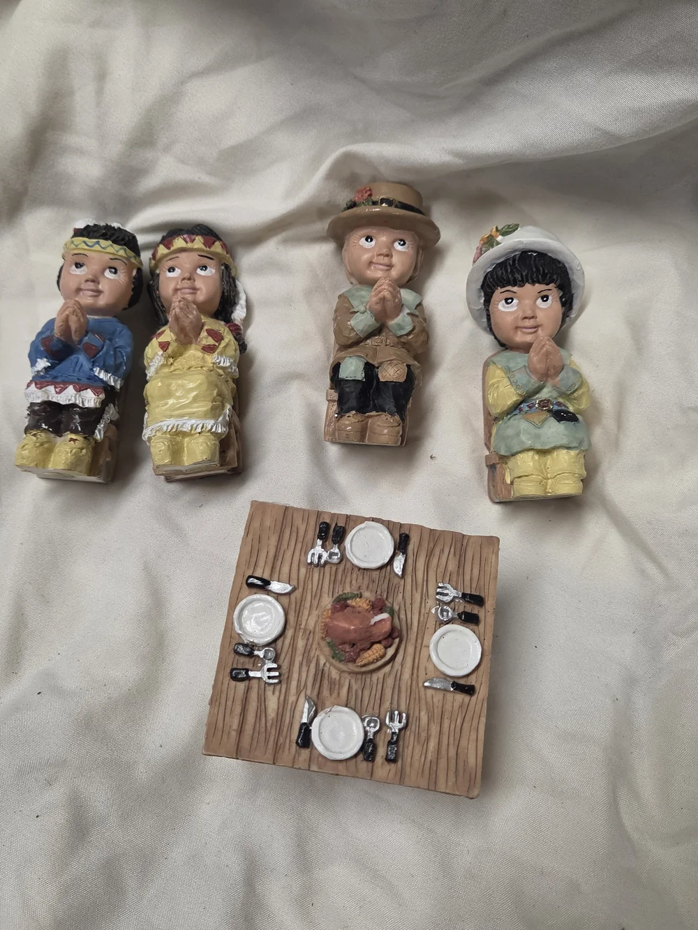 vintage miniature Thanksgiving figurines depicting praying Pilgrim And Native